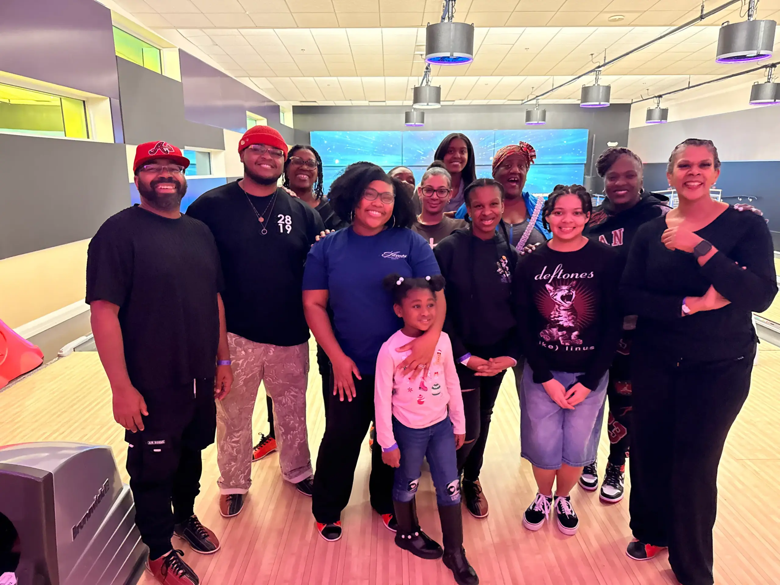 Families and friends gathered at a bowling alley for an autism community outing